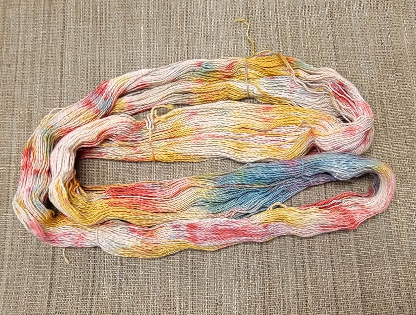 Dyed Cotton / Linen Blend Yarn. Red, Blue, Yellow and White. Fingering Weight. Great for knitting, crochet, and weaving. Assigned Pooling.